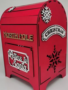 a red mailbox with the words north pole and letters to santa written on it