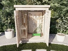 a small wooden outhouse sitting on top of a lush green field