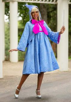 a woman dressed in a blue dress and pink scarf