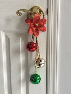 a door handle with bells attached to it and a bow hanging from the front door