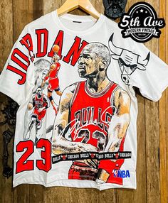 #michaeljordan #basketball #nba #tshirt #tee #streetwear #vintagereprint #y2k #shopvintage #thrift #thriftshop #90sstyle #vintageclothing #vintaget #bootleg Custom Artwork Crew Neck Top For Fan Merchandise, Fan Apparel Tops With Character Print For Sports Events, Crew Neck Tops With Custom Artwork For Fan Merchandise, Throwback T-shirt With Sublimation Print For Fans, Streetwear Graphic Tee With Character Print, Graphic Tee With Character Print For Streetwear, Graphic Tee With Sublimation Print For Fan Events, Graphic Tee Tops With Custom Artwork For Fans, White Character Print Tops For Fan Events