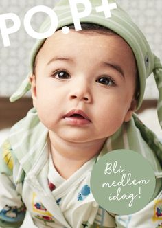 a baby wearing a green hat with the words pop on it