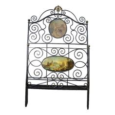 an iron headboard with two paintings on it