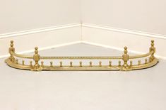 a gold bed frame sitting on top of a white floor