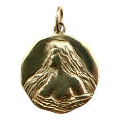 This is part of Chairish’s Fine Jewelry assortment.  The image on this 14k gold medallion was originally taken from an Art Nouveau locket. Kirsten’s Corner created a mould using the face of the locket, and then hand-carved details to emphasise and add depth to the original design. The maiden is surrounded by long flowing hair that morphs into the water that surrounds her. She wears the water wrapped around her almost like a negligee, revealing her bare breasts in the seductive, graceful image. T Art Nouveau Locket, Flowing Hair, Gold Medallion, Art Nouveau Jewelry, La Face, Signature Collection, Gold Pendant Necklace, Vintage Gold, Gold Pendant