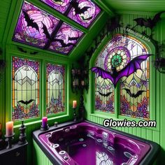 a bath tub sitting next to two windows with stained glass on the walls and ceiling