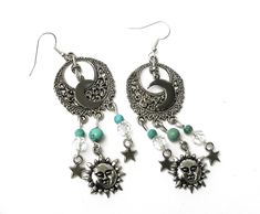 "Fun, flirty earrings with celestial charm that feature sun, half moon, and star charms swinging from filigree pendants with turquoise magnesite and glass bead accents! It's a super-cute pair of earrings to slip on to add that funky finishing touch to your outfits! And the're lightweight, too, so they're really comfortable to wear...no pulling as they swing! Choose your earwires...sterling silver or silver-plated! Sterling Silver/Silver-plated Earwires, Silver-plated Filigree Pendants 1\" round, Celestial Sun And Moon Dangle Jewelry, Adjustable Sun And Moon Design Drop Earrings, Bohemian Dangle Earrings With Sun And Moon Design, Festival Sun And Moon Dangle Jewelry, Bohemian Dangle Charm Earrings, Bohemian Dangle Earrings With Charms, Bohemian Jewelry With Dangle Moon Charm, Celestial Turquoise Jewelry For Jewelry Making, Celestial Nickel-free Jewelry For Festivals