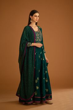 Editor's Note Featuring a zardozi embroidered brocade anarkali with flat chiffon dupatta and trousers Color: Bottle green Fabric: Viscose brocade, cotton satin, flat chiffon Embroidery details: Applique, gota and thread embroidery Anarkali length: 57", trouser length: 38" Components: Anarkali, trouser & dupatta Occasion: Festive Care: Dry clean only About the Designer Shyam Narayan Prasad started his journey in the Indian Fashion Design Industry with a couture women’s wear collection. The design Brocade Anarkali, Embroidery Anarkali, Chiffon Embroidery, Blouse Yoke, Embroidered Anarkali, Personal Shopping Service, Casual Tunics, Chiffon Dupatta, Thread Embroidery