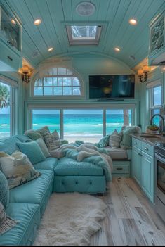 a living room filled with lots of furniture next to an ocean front kitchen and breakfast nook