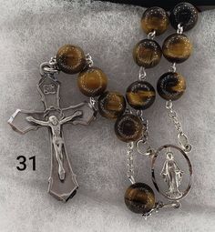 "10mm Natural Tiger Eye Bead,   crucifix 1.875\"h x 1.25\"w silver finish over pewter,  center .75\"h x .5\"w silver finish" Nickel-free Silver Cross Rosary Bracelet, Spiritual Crucifix Jewelry With 8mm Beads, Silver Cross Rosary As Gift, Sterling Silver Spiritual Rosary With Crucifix, Adjustable Silver Crucifix Rosary, Spiritual Sterling Silver Crucifix Rosary, Silver Rosary Bracelet With 8mm Beads As Gift, Adjustable Silver Rosary With 8mm Beads, Adjustable Silver Rosary With Round Beads