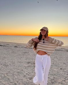 beach outfit, tan striped sweater, white beach pants Sunset Outfits Beach Comfy, Cute Beach Outfits Cold Weather, Comfy Beach Outfit Winter, Covered Beach Outfit, 60 Degree Beach Outfit, Chilly Beach Day Outfit Casual, Cold Beach Sunset Outfit, Beach Cleanup Outfit, Comfy Beach Outfit Cold