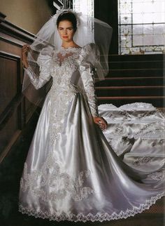 a woman in a wedding dress standing on stairs