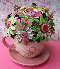 a tea cup with flowers in it sitting on a saucer