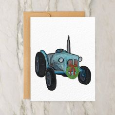 a greeting card with an image of a blue tractor on it's front and side