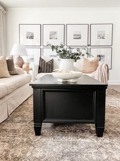 a living room filled with furniture and pictures on the wall above it's coffee table