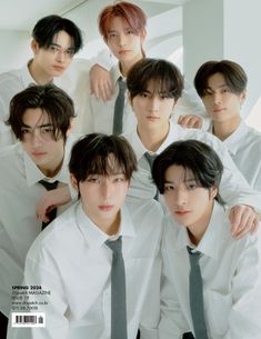 the group of young men are posing together for a photo in white shirts and ties