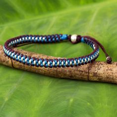 This unique braided bracelet presented by Napapat is inspired by the Hill Tribe artisans of Thailand. She hand braids turquoise blue and dark red polyester cords to craft this bracelet with silver beaded accents. It features a sliding knot for easy adjustment. Hill Tribe Silver, Wristband Bracelet, Silver Bead Necklace, Braided Bracelet, Sliding Knot, Silver Charm Bracelet, Women Artisans, The Hill, Silver Pieces