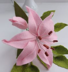 a pink flower with green leaves on it