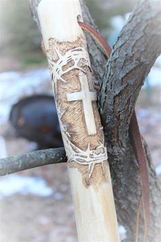 a cross is wrapped around a tree branch