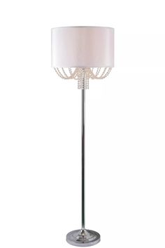 a floor lamp with a white shade on it's side and a silver base