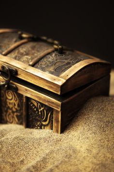 the ark and the shadow book cover with an open wooden box on top of sand