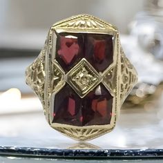 "VINTAGE 14K WHITE GOLD ANTIQUE GARNET ART DECO COCKTAIL RING BEAUTY!!     Size 5.25     Each garnet measures approximately 5mm x 4mm     Ring face measures 3/4\" high x 6/16\" wide.     3.6 grams One of the garnets are scratched across (see pics). Not cracked through. Shipped insured/delivery confirmation I guarantee item to be exactly as described and pictured." Victorian 14k Gold Diamond Cut Rings, Victorian Yellow Gold Cluster Ring With Diamond Cut, Victorian Cluster Ring In Yellow Gold With Diamond Cut, Antique Yellow Gold Diamond Cut Ring, Antique 14k Gold Signet Ring With Gemstone, Victorian Gold Signet Ring With Gemstone, Antique Gold Ruby Ring Stamped 14k, Antique Gold Signet Ring With Gemstone, Antique 14k Yellow Gold Ruby Ring