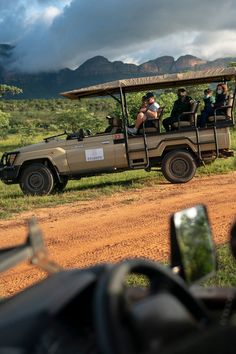 people are riding in the back of a safari vehicle