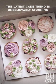 a box filled with cupcakes covered in pink and white frosting