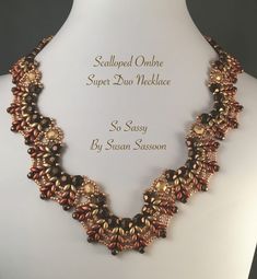 the necklace is adorned with gold and brown beads