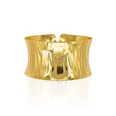 Gold-plated over brass. Adjustable. Gold Polished Cuff Bracelet, Modern Gold Cuff Bracelet With Wide Band, Modern Gold Wide Band Cuff Bracelet, Polished Brass Bangle Cuff Bracelet, Polished Metal Cuff Bangle, Polished Brass Cuff Bracelet, Metal Cuff Bangle With Polished Finish, Modern Gold Hammered Cuff Bracelet, Modern Hammered Gold Cuff Bracelet