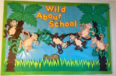 a bulletin board with monkeys hanging from it's sides and the words wild about school