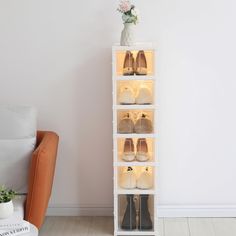 a tall white shelf with shoes on it