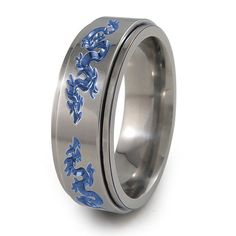 a wedding ring with blue flowers on the inside and silver in the outside, is shown