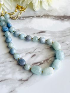 "Oh these gorgeous blues!! She is a fabulous mix of 8mm Aquamarine, Blue Aventurine pebbles and incredible 13mm Aquamarine nuggets with 2mm Ethiopian Brass Heishi between each stone!! Casual or all dressed up, she's wonderful! Necklace is 17\" long Chain is Gold electroplated cable chain  Clasp is a 15mm Lobster Claw All metal is nickel and lead free" Aquamarine Necklaces With Round Beads Of Natural Stones, Aquamarine Necklace With Natural Round Beads, Aquamarine Necklace With Round Natural Stone Beads, Aquamarine Necklace With Round Natural Stones, Blue Amazonite Gemstone Beads Necklace, Blue Amazonite Round Bead Necklaces, Blue Amazonite Necklaces For Jewelry Making, Blue Amazonite Beaded Necklace With Polished Beads, Blue Amazonite Polished Beads Necklace