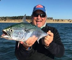 a man holding a fish in his hands