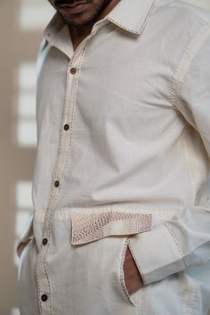 This Dawning Flap Detailed Shirt comes in a calm and soothing color. A contemporary take on the classic long sleeve shirt. This 60s cotton button-down shirt is undyed and unbleached. Details include intricate Kantha stitches, a form of Indian hand embroidery on the faux flaps and pockets. *This item is a final sale and not eligible for returns or exchanges. *This item can take up to 14 business days to ship as it is made to order for you. Traditional Long Sleeve Shirt With Button Closure, Cream Cotton Button-up Shirt, Beige Cotton Tops With Button Cuffs, Cream Long Sleeve Shirt With Button Cuffs, Beige Cotton Button-up Shirt, Beige Cotton Shirt With Button Closure, Traditional Long Sleeve Linen Shirt, Cream Cotton Shirt With Buttons, Cream Cotton Shirt With Relaxed Fit