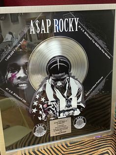 a silver record with an image of asap rocky on it