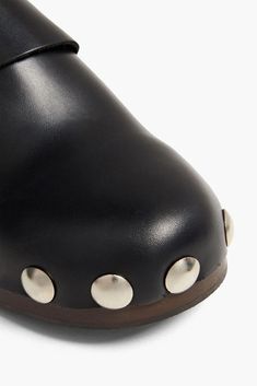 These studded leather clogs make a striking statement with their round toe shape, buckled straps, and wooden heel embellished with metal studs. Perfect for your Instagram feed, the buttery soft leather and slip-on design provide an effortlessly cool look you can wear both indoors and out. Featuring a rubber sole for traction and flexibility, they come in import sizes true to fit. Black Clogs With Studded Rubber Outsoles And Round Toe, Spring Slip-on Clogs With Studded Rubber Outsoles, Casual Studded Slip-on Clogs, Leather Slip-on Clogs With Stitched Sole, Black Slip-on Clogs With Buckle Closure, Platform Mules, Clog Sandals, Wooden Heel, Leather Clogs