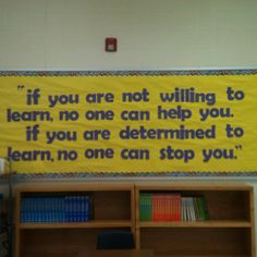 a bulletin board with a quote on it in a school library area that reads, if you are not waiting to learn, no one can help you