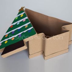 an open cardboard box with a christmas tree on it