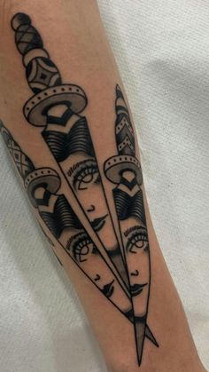 a black and white tattoo with three arrows