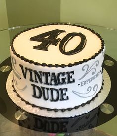 a cake with the number forty on it sitting on top of a glass platter