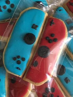 decorated cookies in the shape of pacman and watermelon are wrapped in plastic