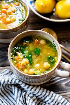 two bowls filled with soup next to lemons