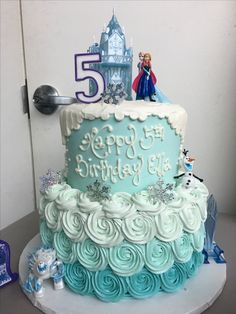 a frozen princess themed birthday cake on a table