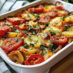 a casserole dish with tomatoes and other vegetables