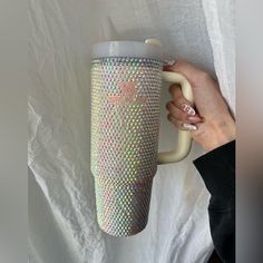 a person holding a coffee cup with holographics on the outside and inside