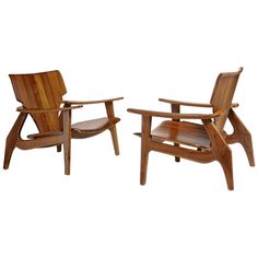 two wooden chairs sitting next to each other