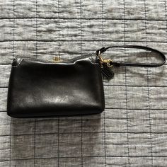 New Without Tags. Brand New, Never Used. 100% Leather. Black Leather Bag With Wrist Strap, Black Leather Wristlet For Evening, Black Clutch Wristlet For Formal Occasions, Black Formal Clutch Wristlet, Black Leather Clutch With Snap Closure, Black Leather Pouch Wristlet, Classic Leather Wristlet For Formal Occasions, Classic Black Handheld Clutch, Coach Black Travel Clutch