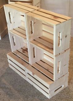 several wooden crates stacked on top of each other in a room with carpeted flooring